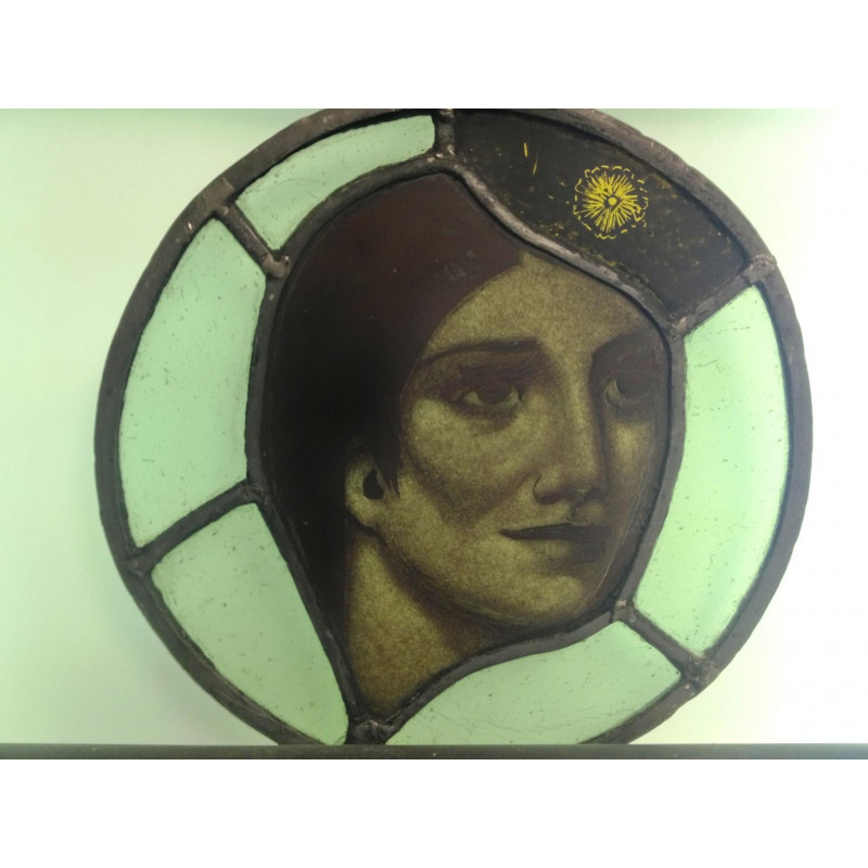 Painted stained glass roundel of womans head